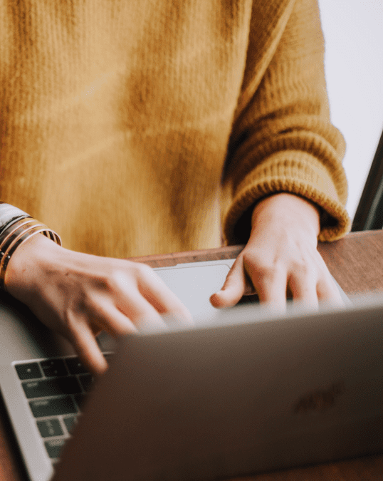 A person typing on a laptop computer.