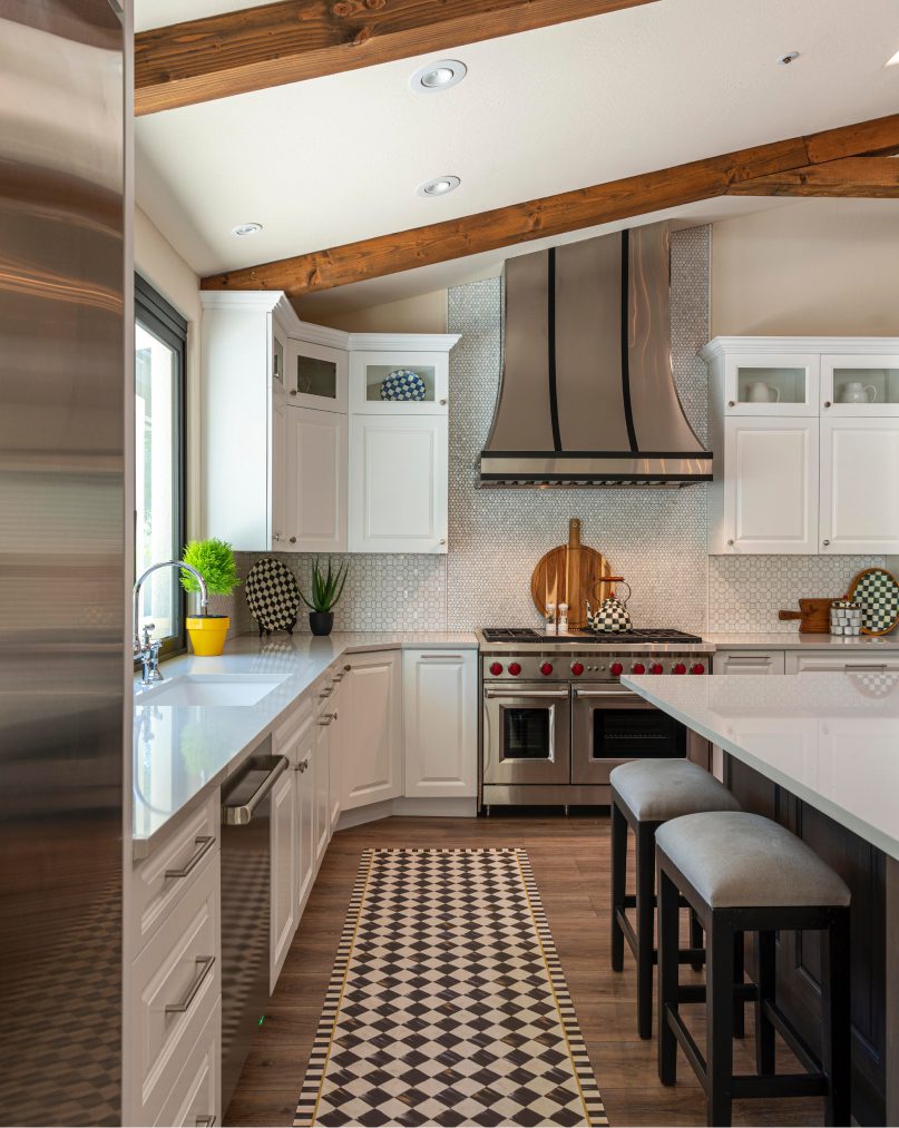 A kitchen with white cabinets and stainless steel appliances.