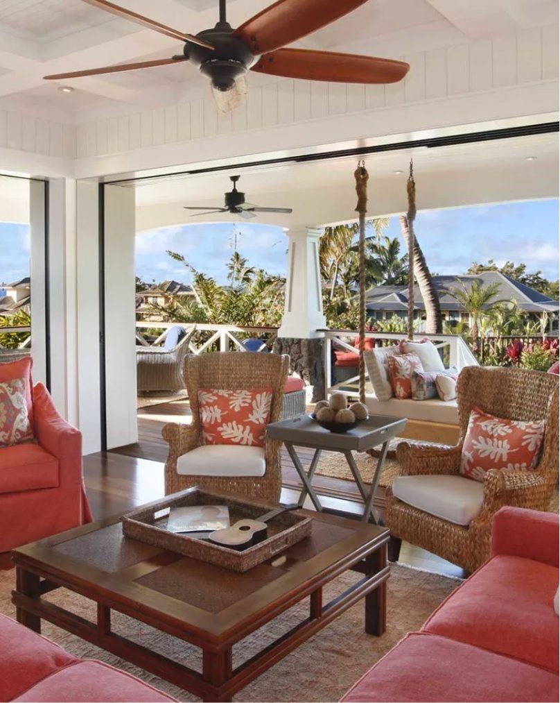 A living room with lots of furniture and large windows.