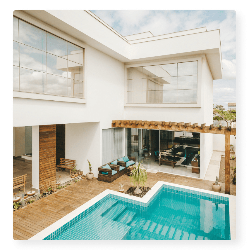 A large pool in front of a house.