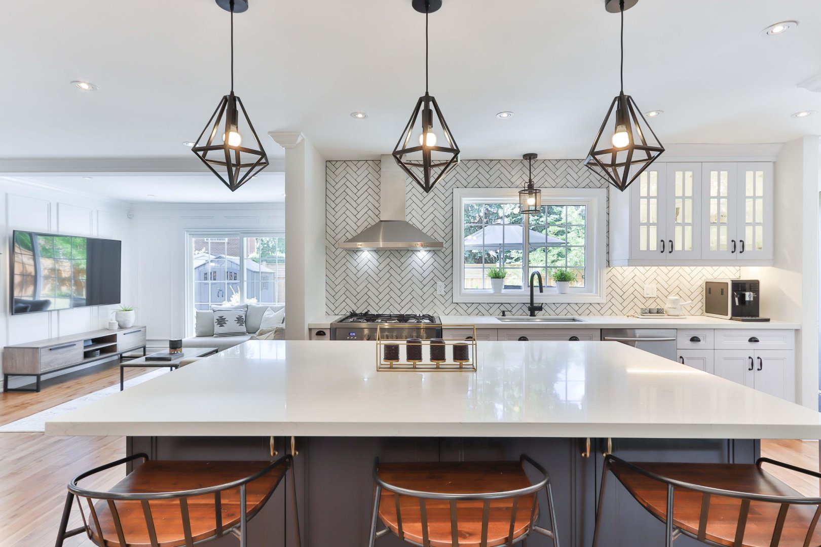 A kitchen with three lights hanging above the island.